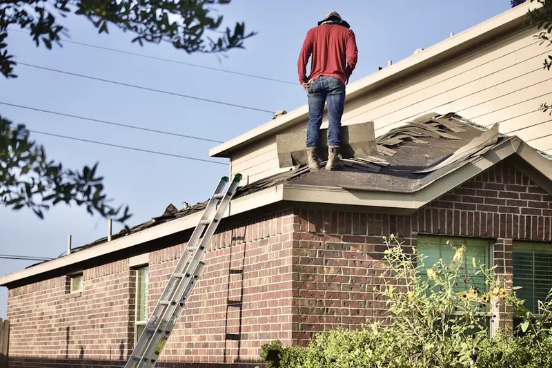 Professional roofer working on a residential roof in Marumsco Village